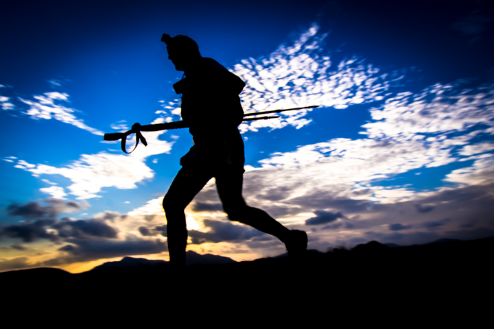 Silhouette of a runner with poles against the Fuerteventura sky