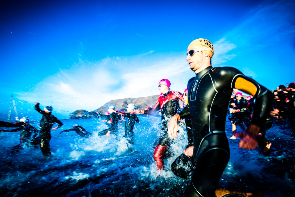Triathletes entering the sea for a swim