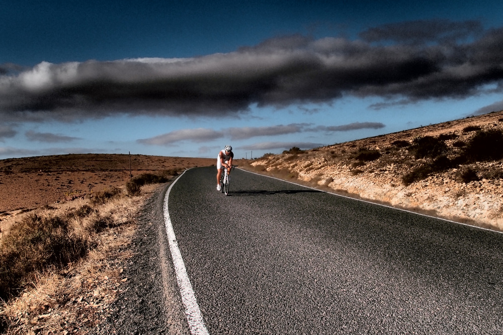 Cyclist in Fuerteventura's volcanic landscape